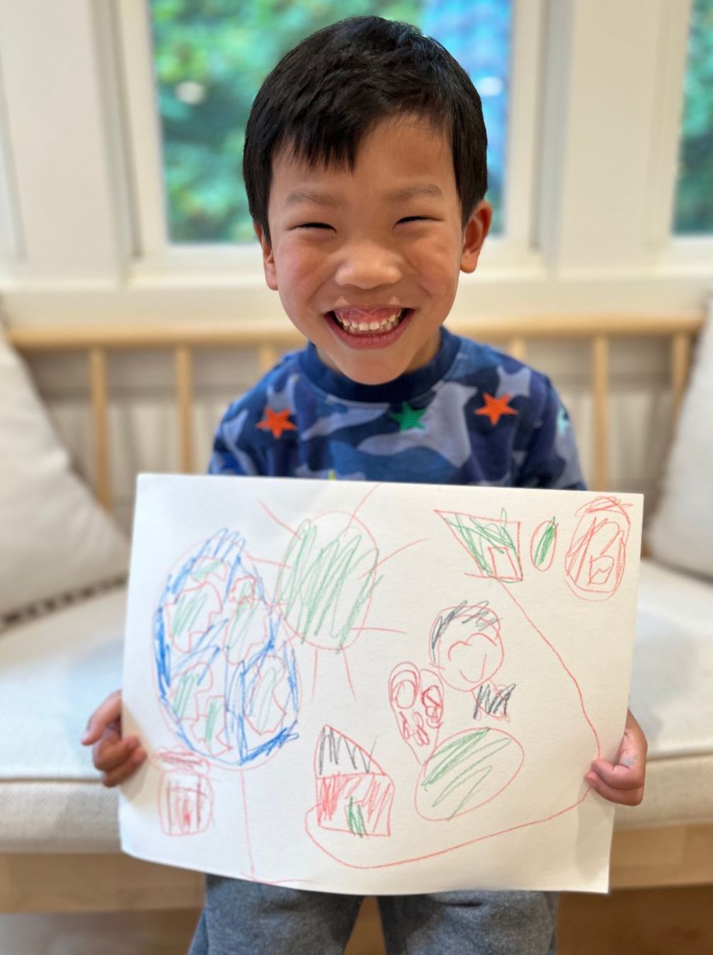 Thaddeus Smiling with Christmas Drawing