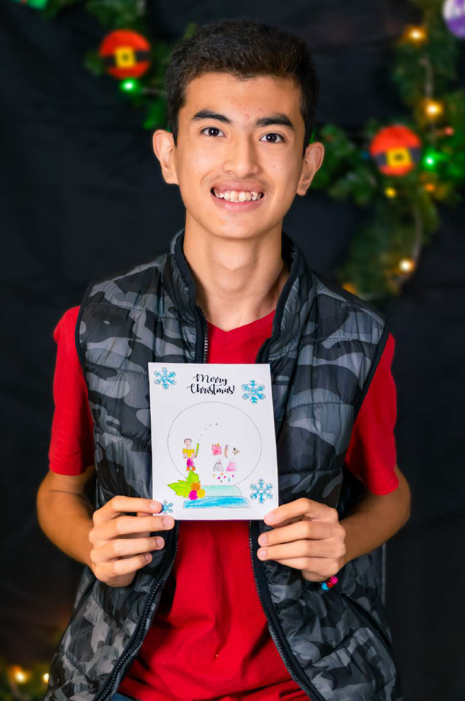 Jose Smiling with Christmas Drawing